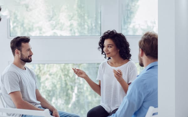 A therapist and two patients in a session togethe