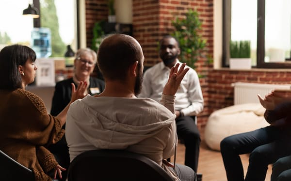 A group of people sit in a circle.